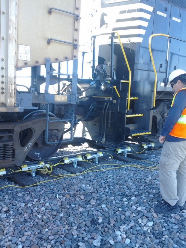 A worker inspecting a railroad track.