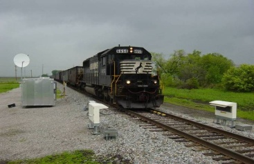 A black train on a cloudy day.