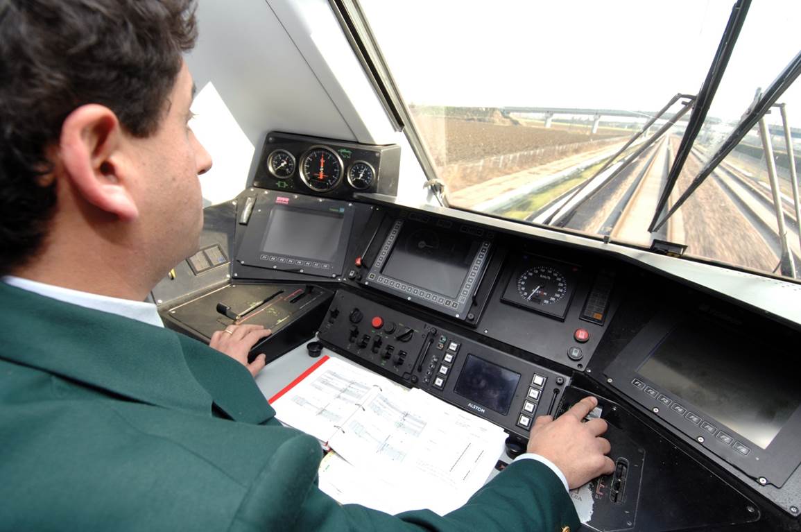 A man conducting a train.