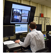 A man monitoring a screen.