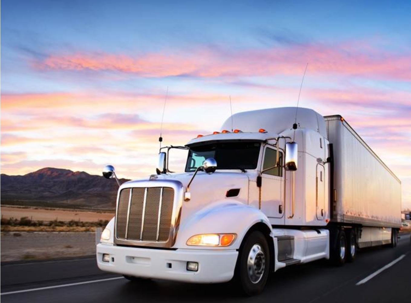 A truck driving at sunset.